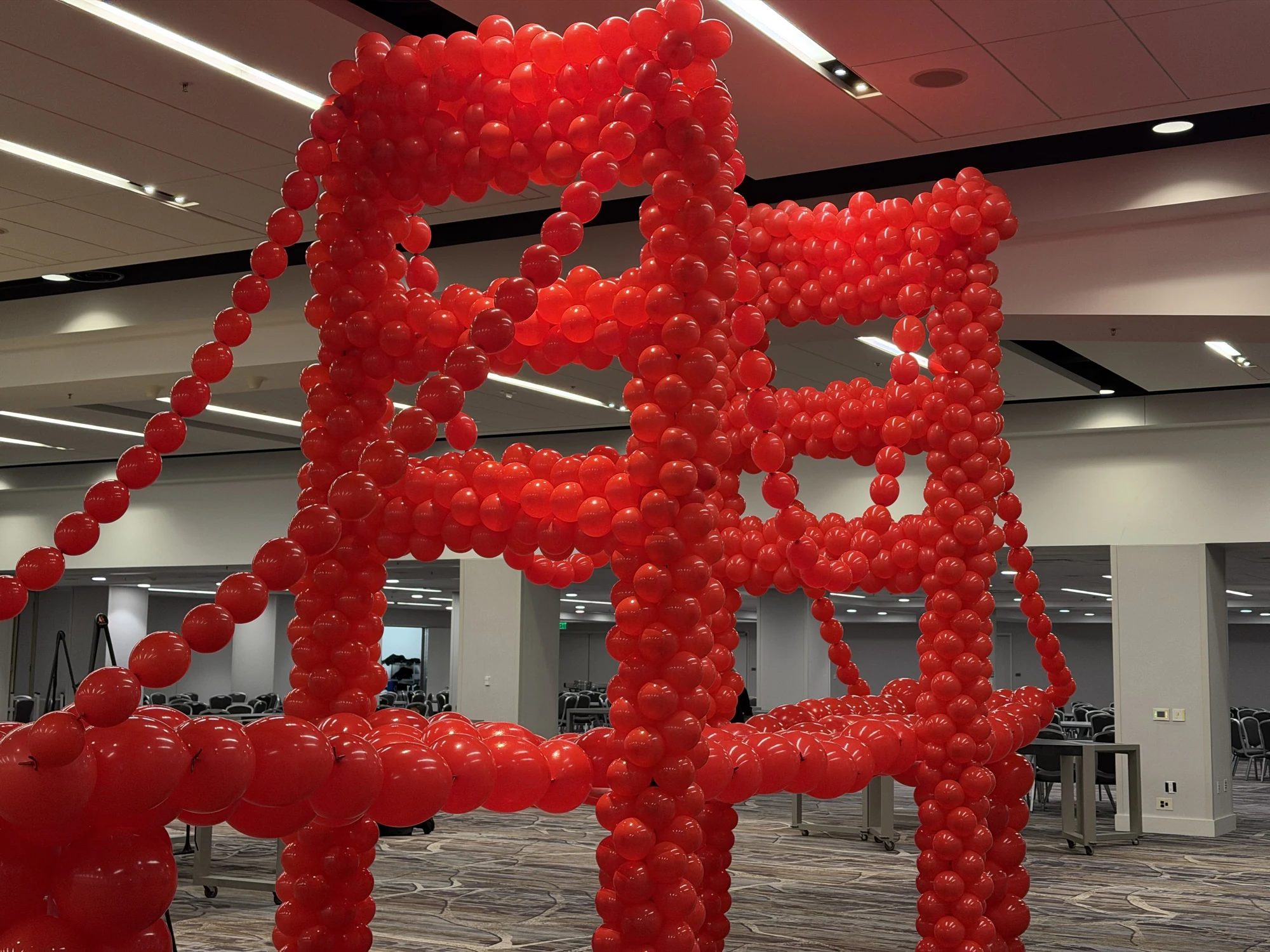 Close view of the red balloon towers and suspension lines on the Golden Gate Bridge sculpture