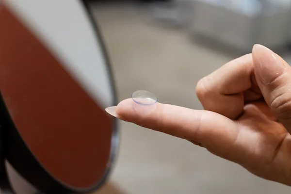 Contact lens held on fingertip at Elite Eyecare Nashville
