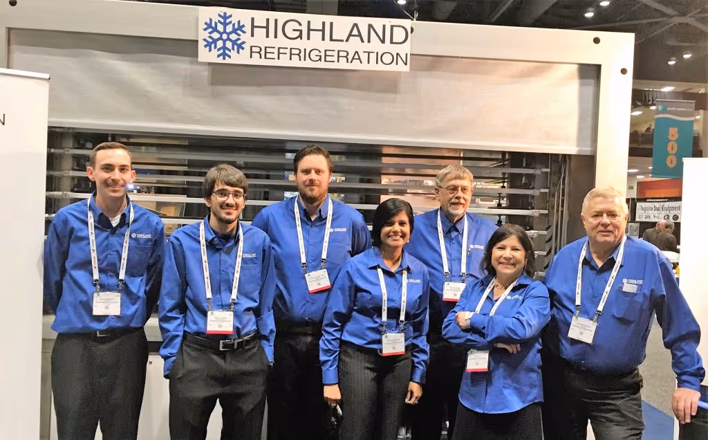 Group photo in front of Highland Refrigeration sign