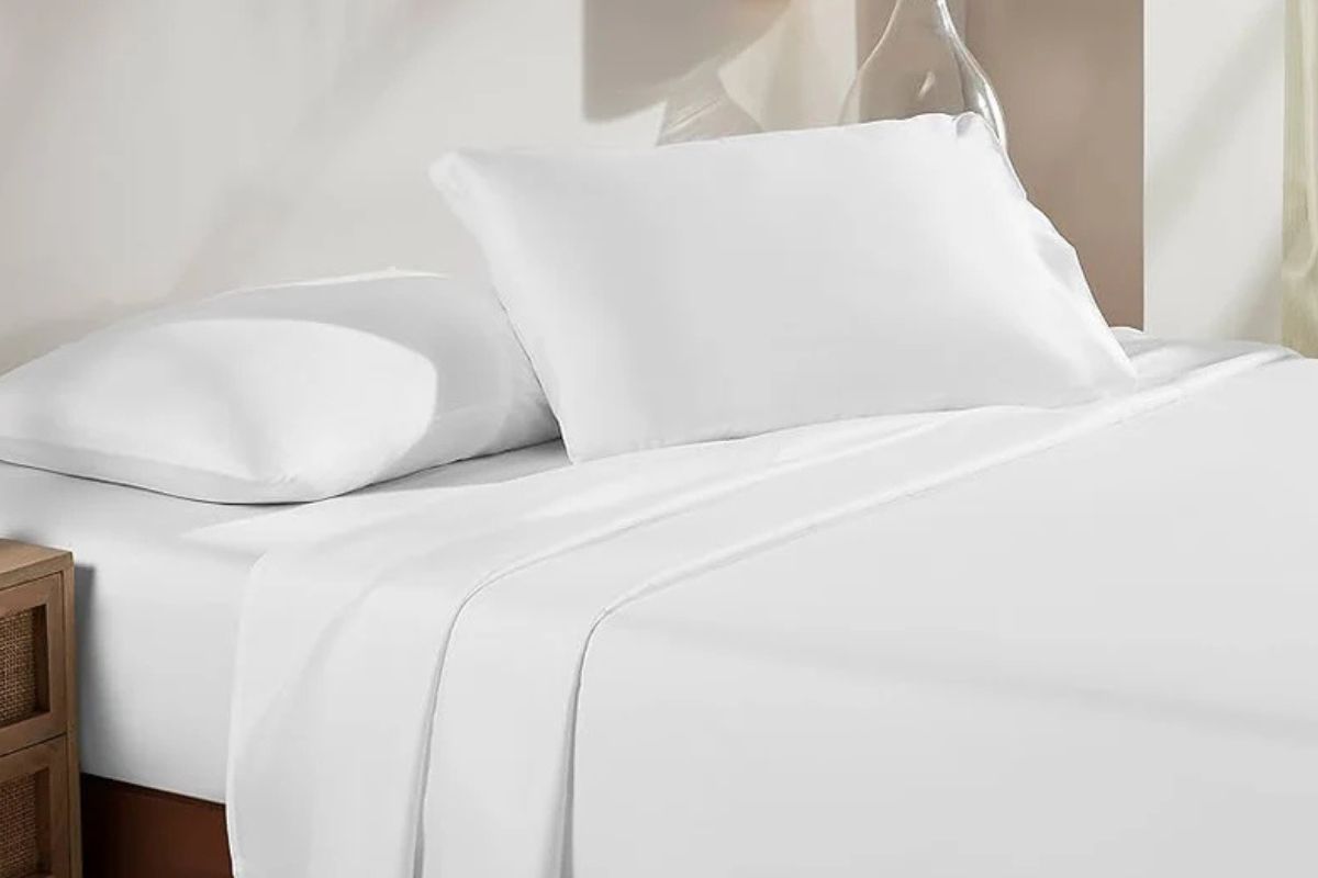 White Standard Textile linens on a bed.
