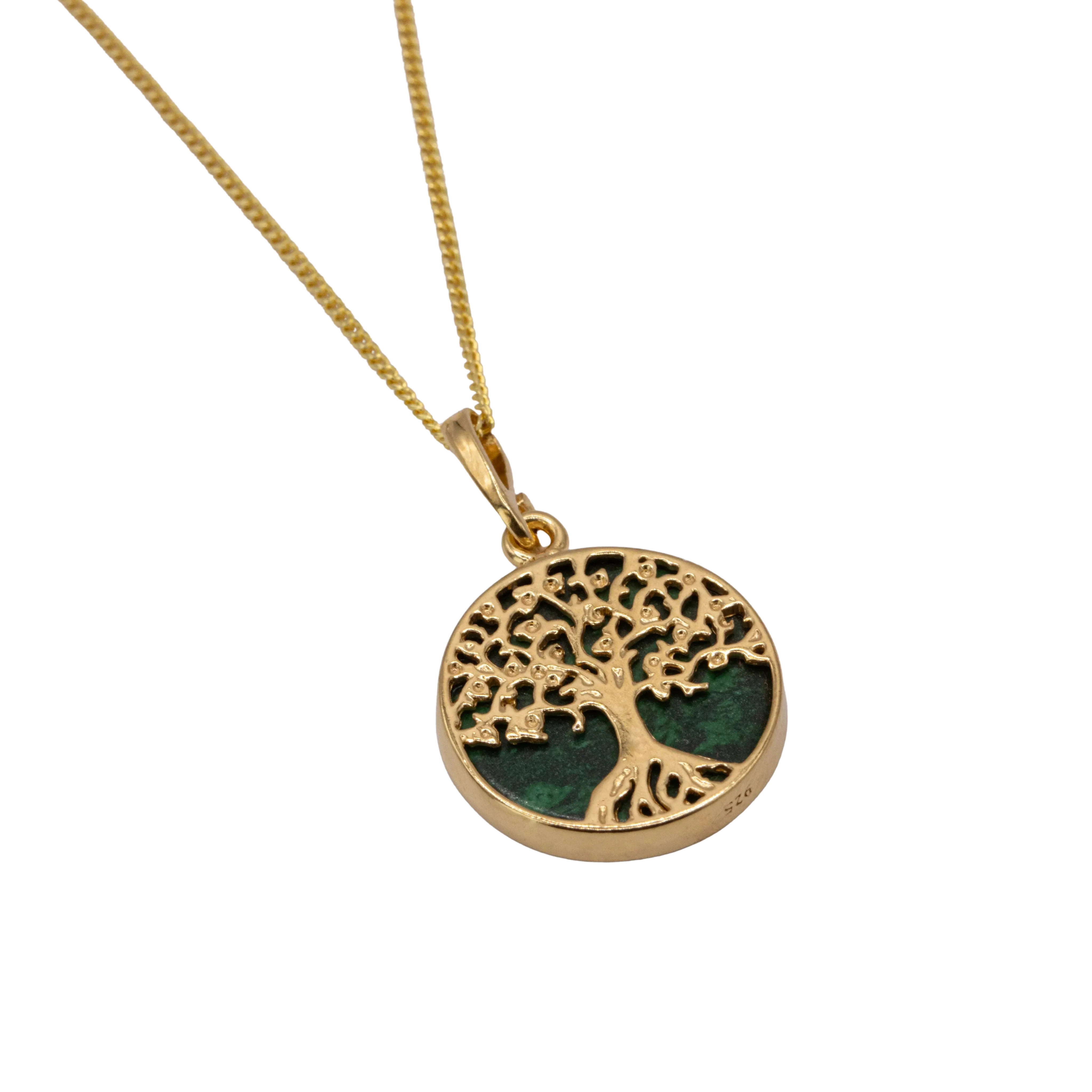 Round malachite gold pendant with a dark green malachite surface and golden tree design atop surface. Pendant is attached to a silver necklace chain