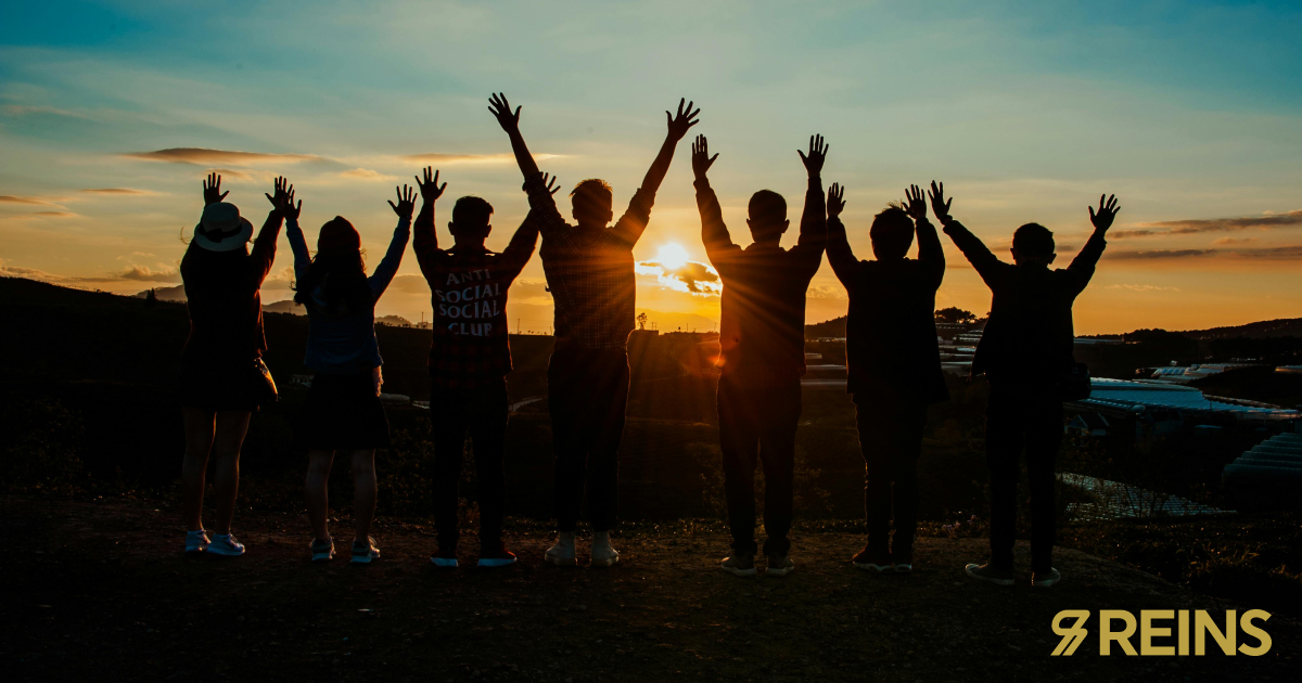 Small business team celebrating together at sunset
