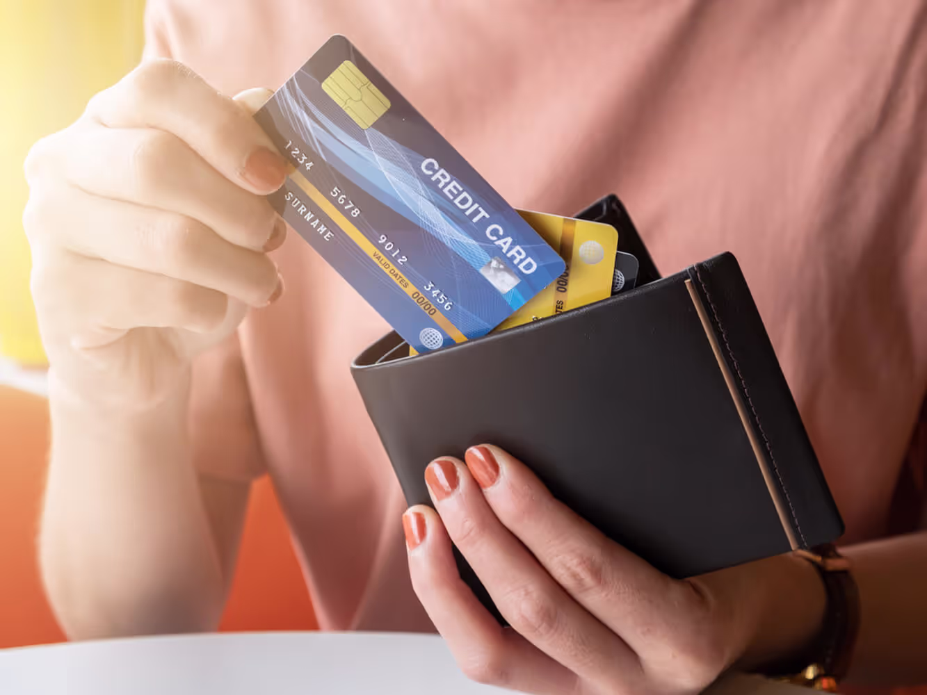 Woman placing a credit card in her wallet