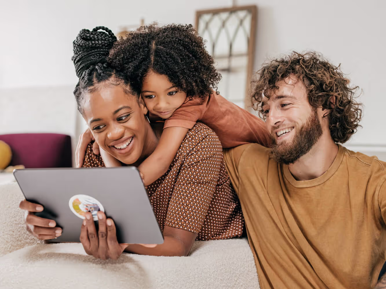 Smiling mother, young daughter and father getting legal estate planning information online