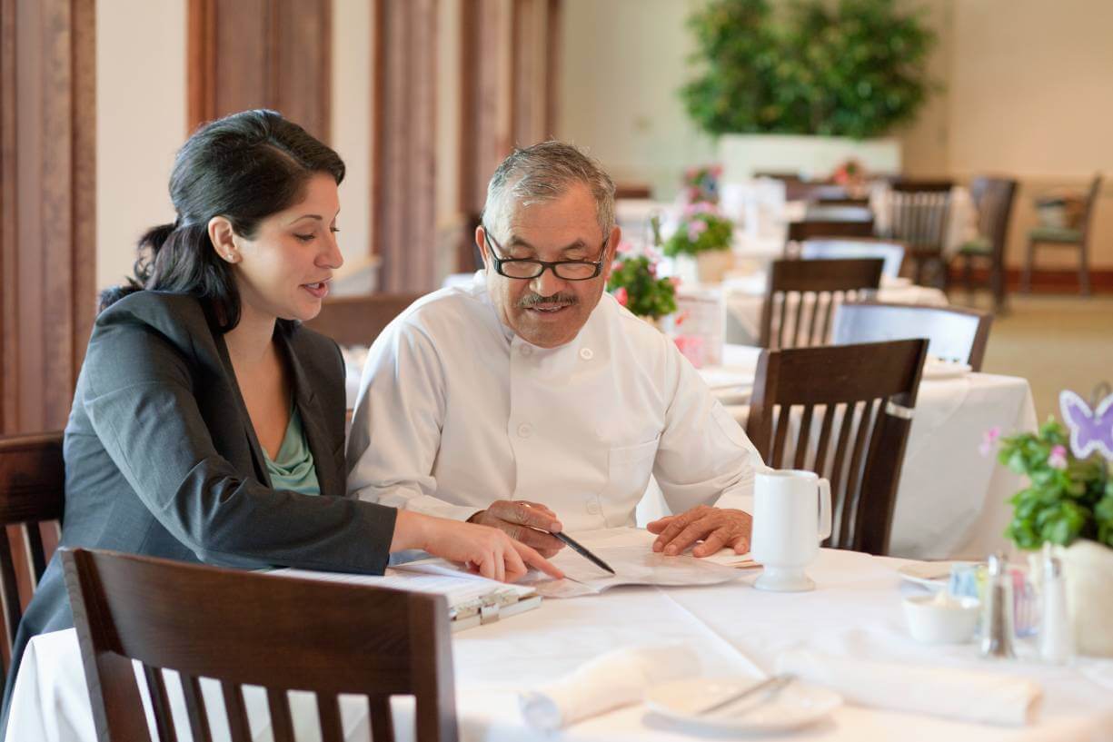 small business restaurant owners reviewing unpaid debt documents