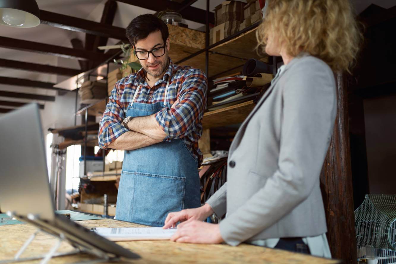 lawyer standing next to small business owner as he consider a dba vs llc
