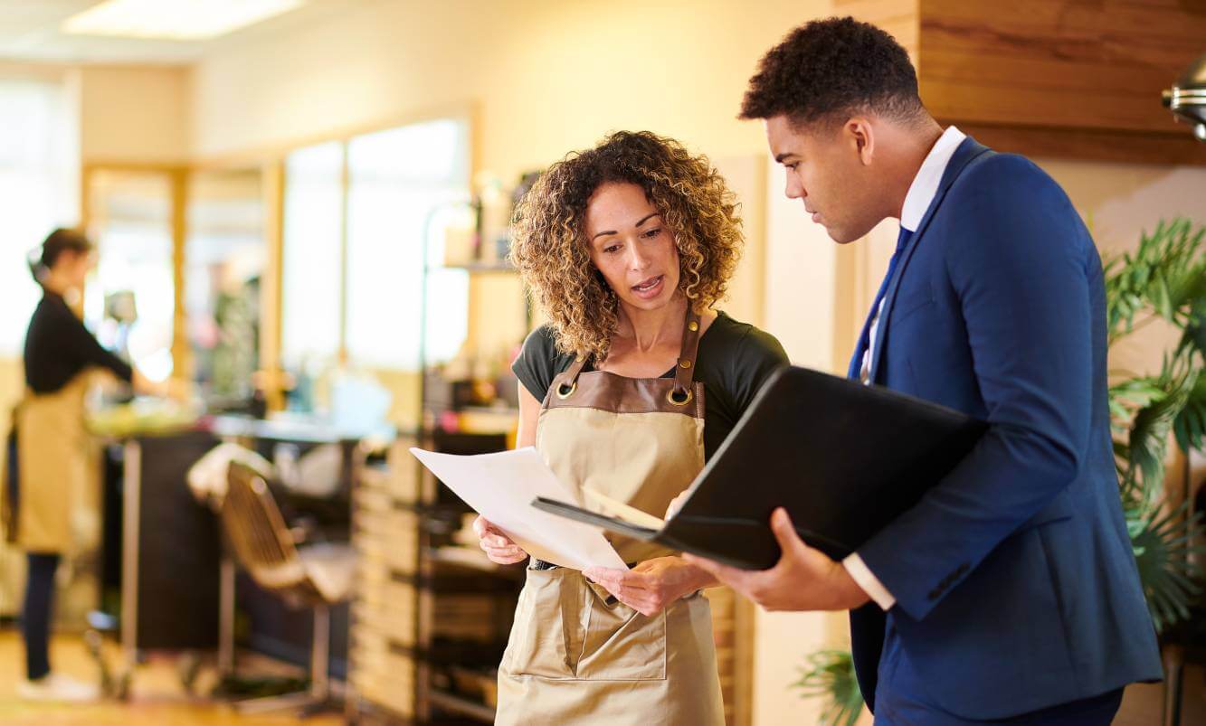 business owner asking lawyer question in her shop