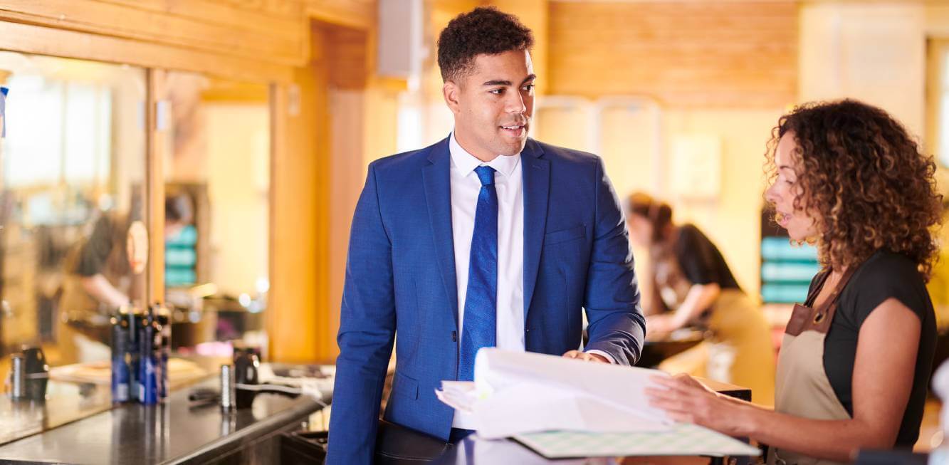 small business lawyer smiling at client as she looks at legal papers