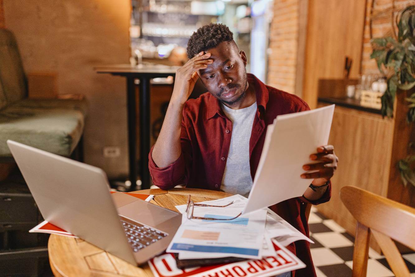 small business owner worried he might need to file for bankruptcy as he reviews business financial documents