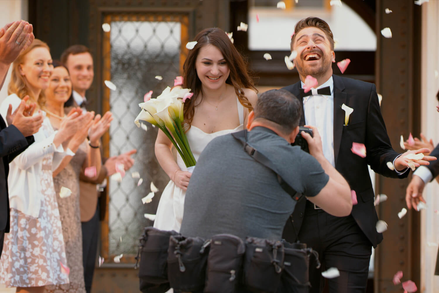 Photographer taking picture of newlywed couple