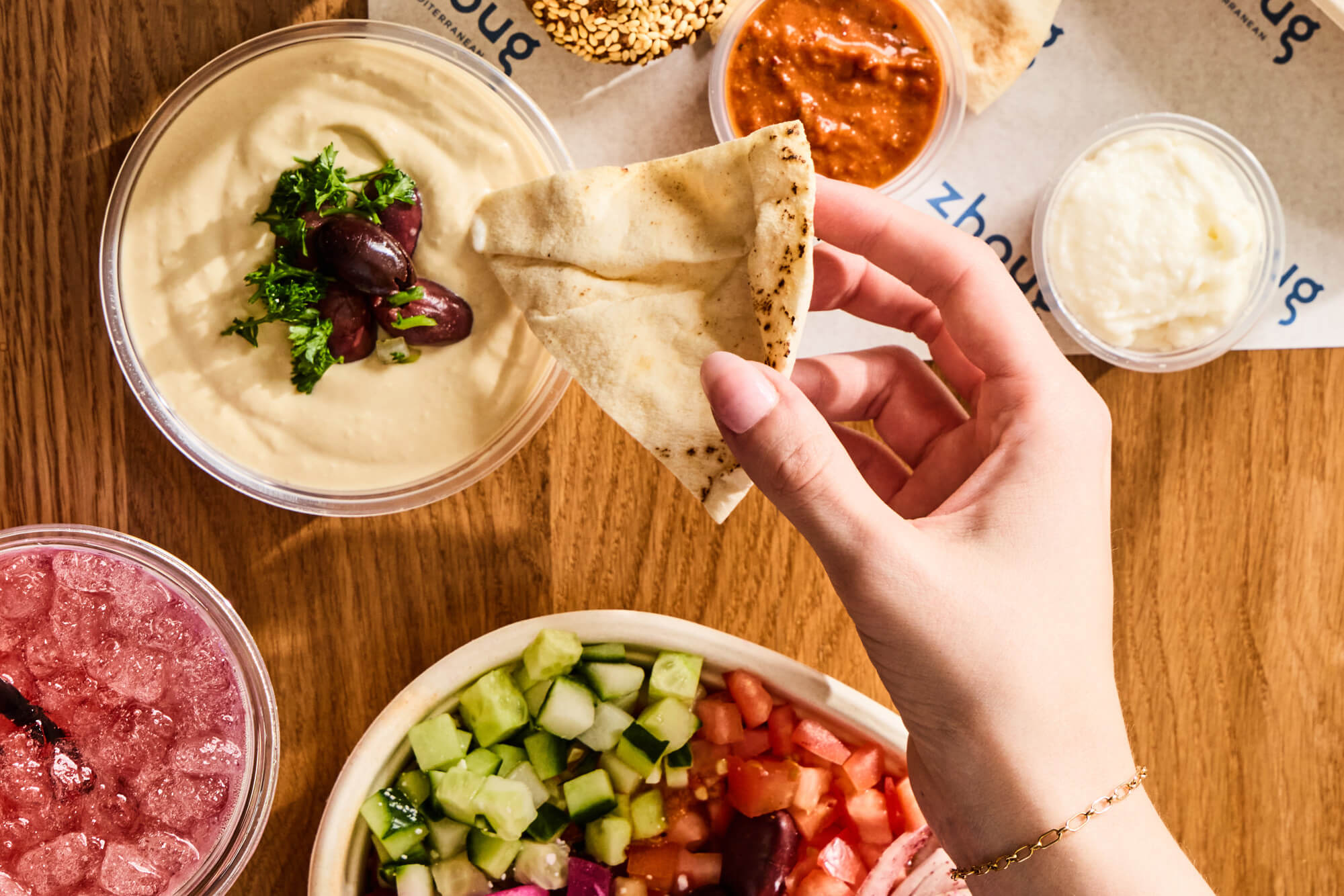 Table spread with toum sauce and hummus.