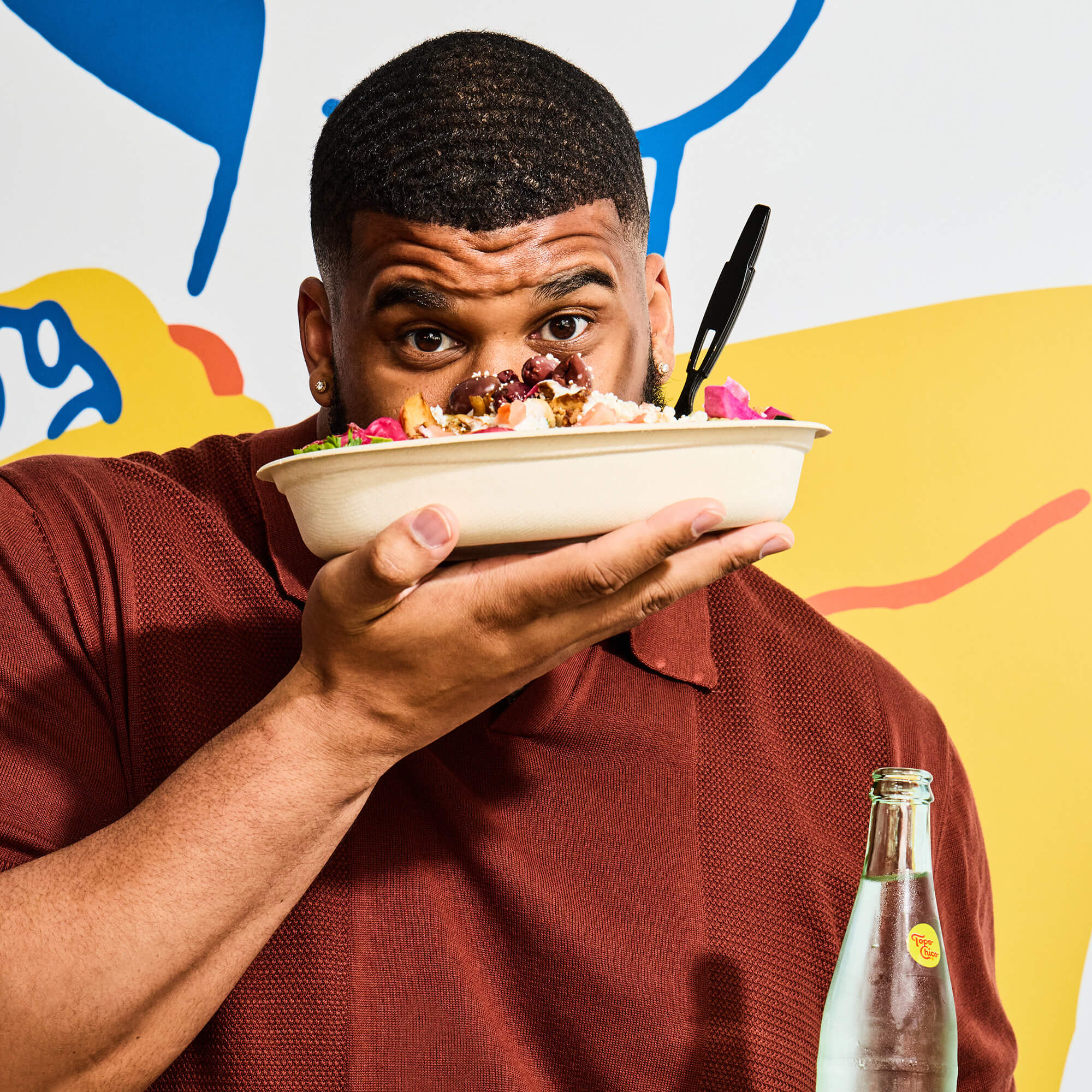 Young man lifting delicious food up to his face.