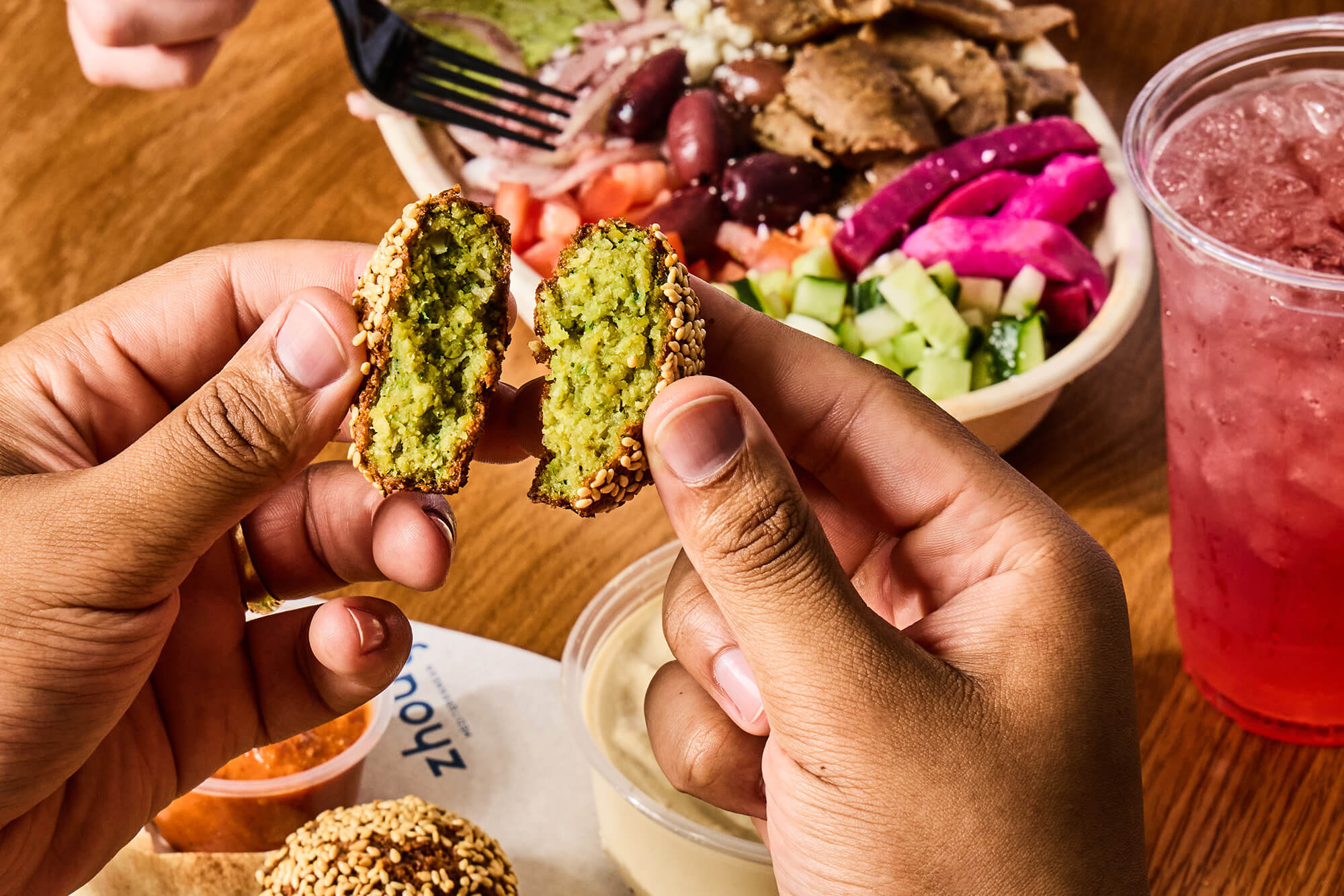 Close up of man eating falafel.