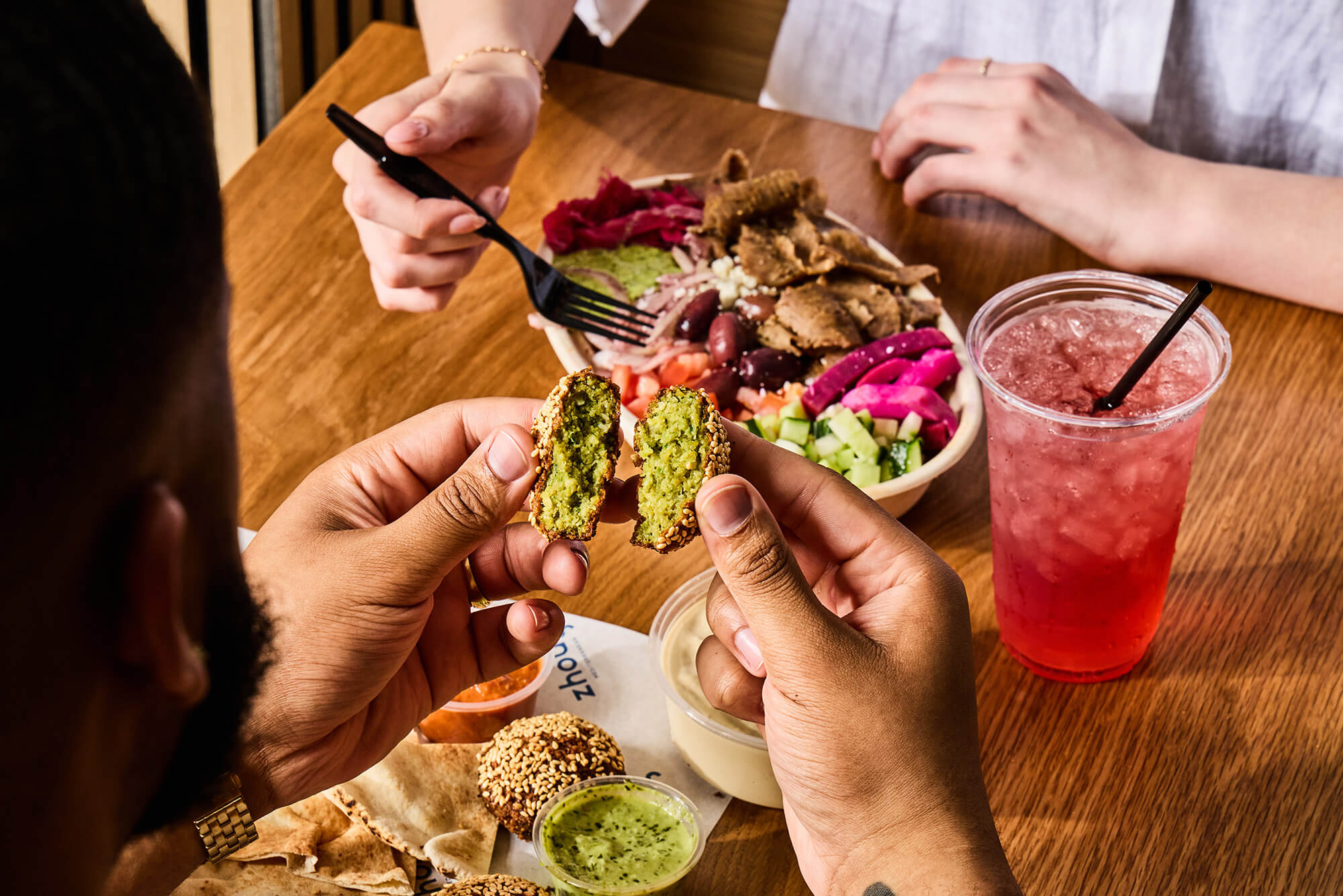 Close up of a table spread with gyro.