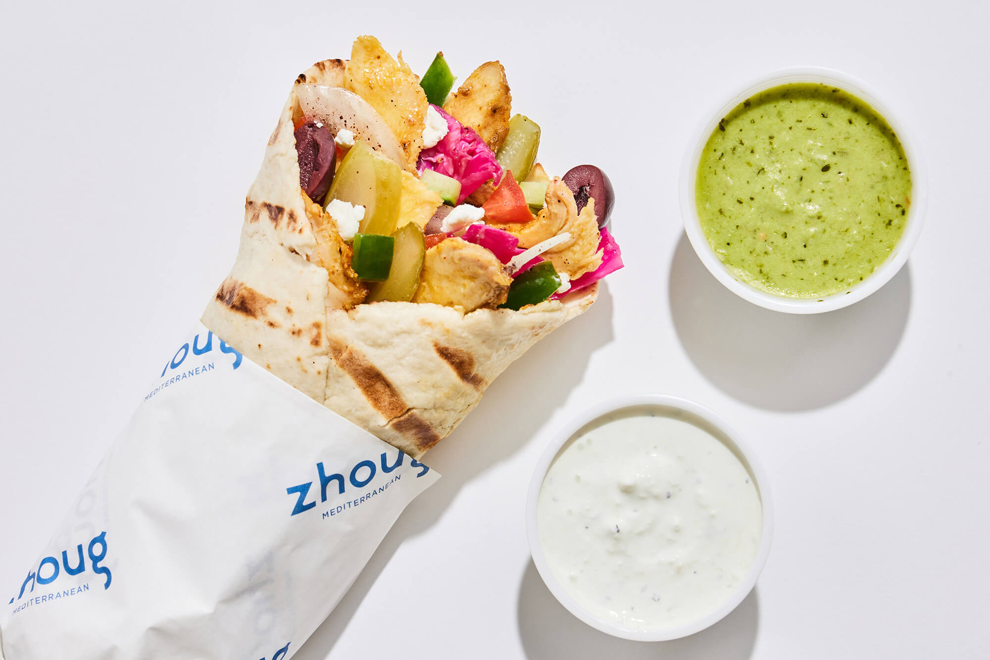 Chicken shawarma pita wrap with two sauces.