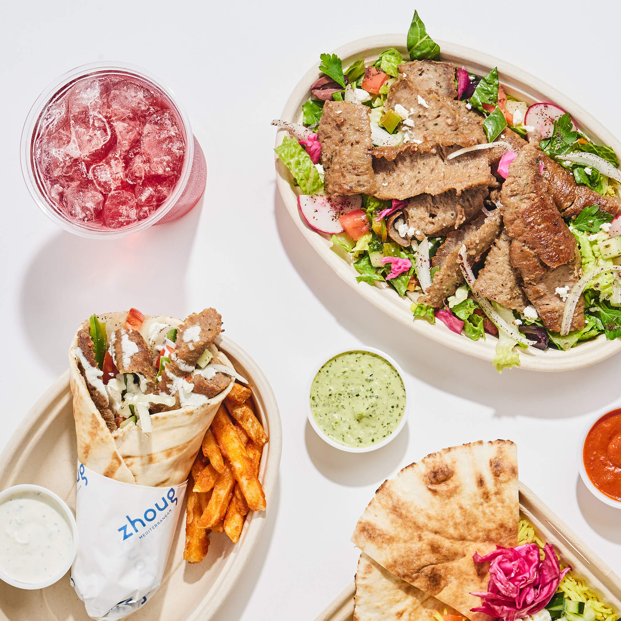 Big spread of Zhoug Mediterranean food.