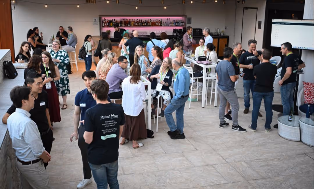 A group of people standing around a bar.