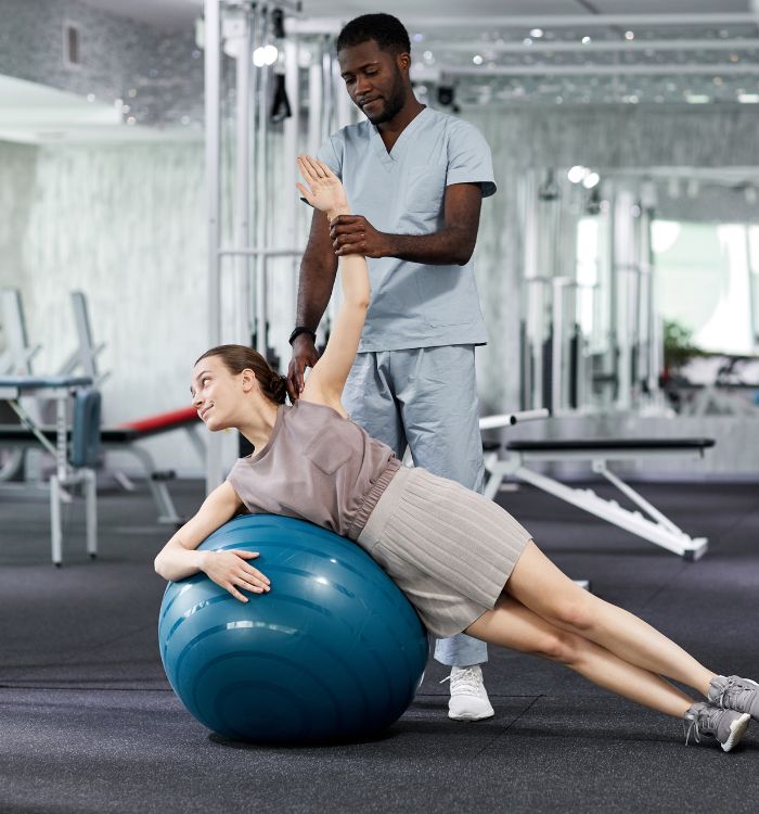 A woman is doing a workout on a blue exercise ball.