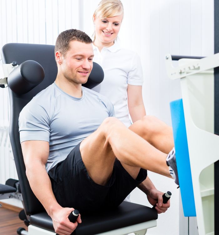 A man in a gym is lifting weights.