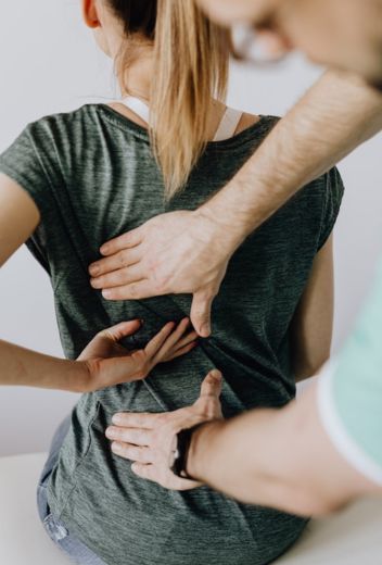 A man gives a soothing back massage to a woman.