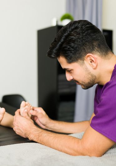  A man is giving a foot massage.  