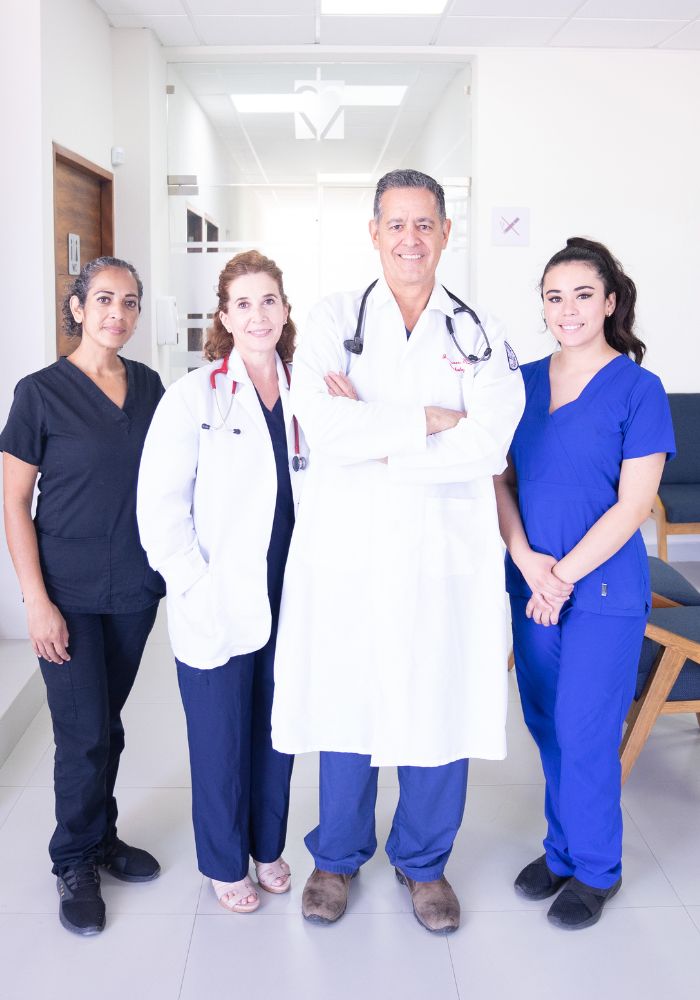 A group of doctors in white coats standing together in a hospital corridor.