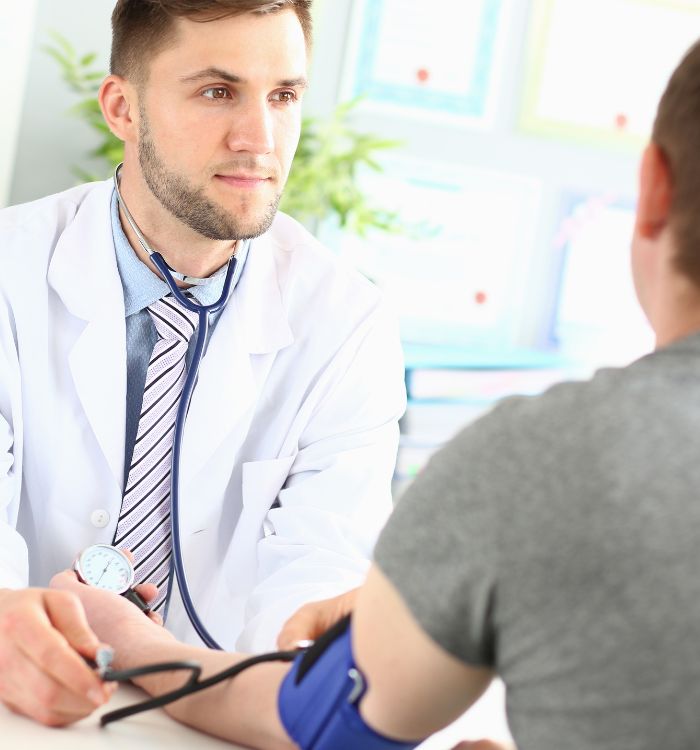 A doctor measures a patient's blood pressure using a sphygmomanometer.
