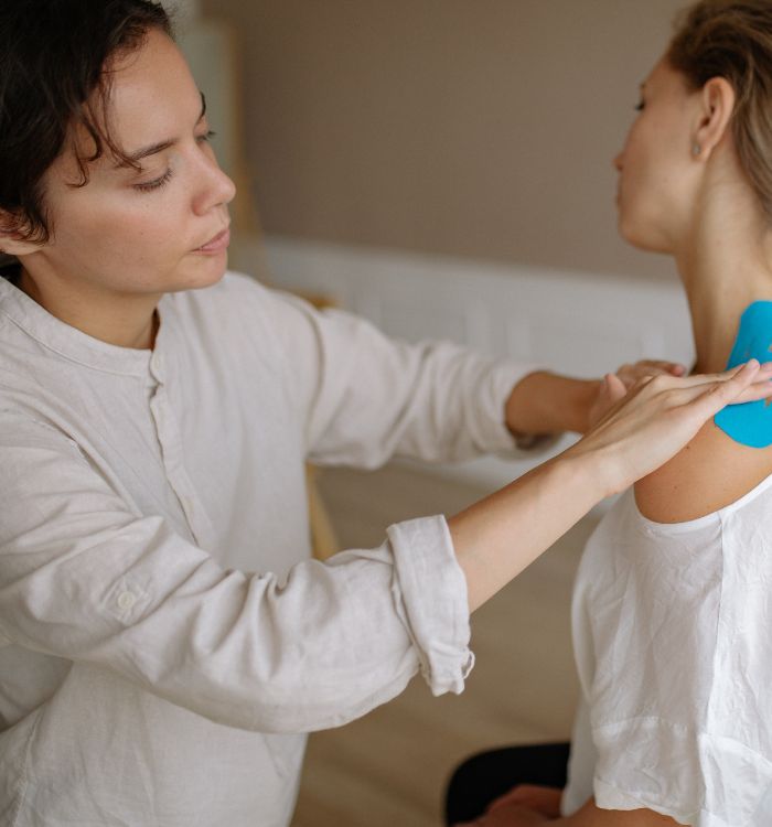 A therapist provides a soothing massage to a woman.