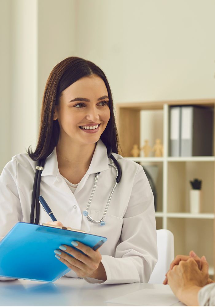 A female doctor engages in a discussion with a patient, providing medical advice and support.