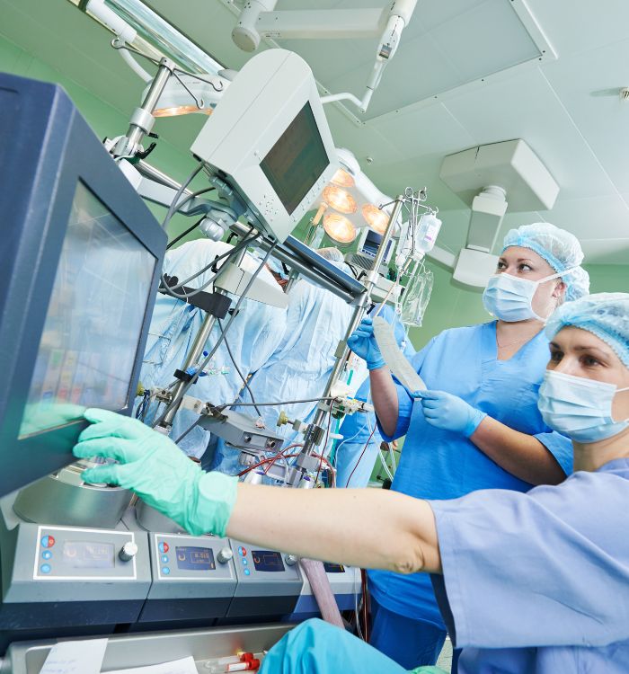 Surgeons working together at a computer in an operating room.