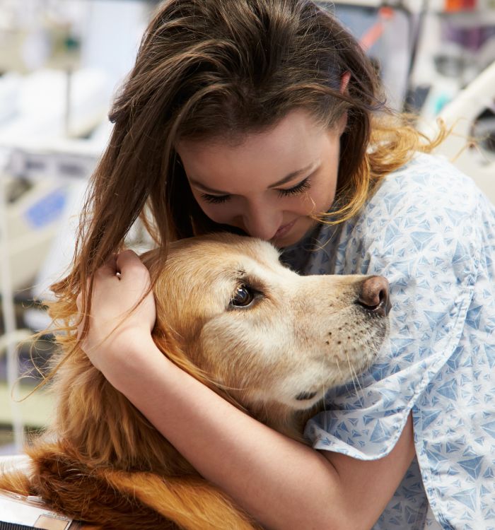 A woman embraces a dog .