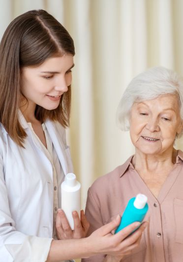 A woman holding a bottle of lotion.