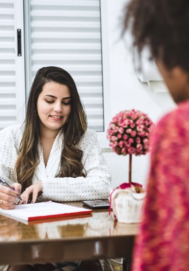 A woman writing in a notebook.