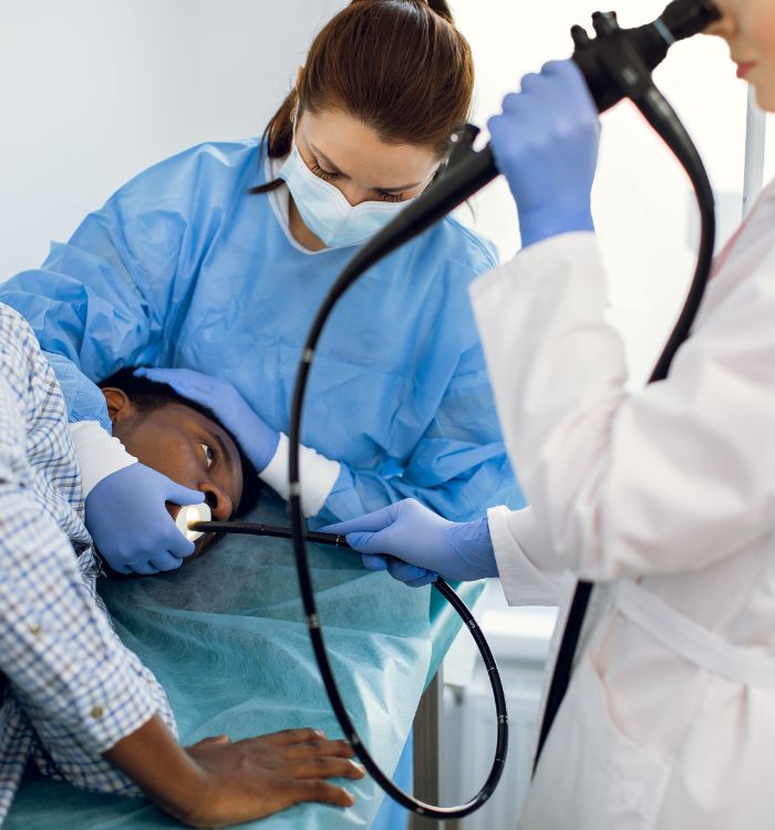 A woman is using a stethoscope to check a man's heart.