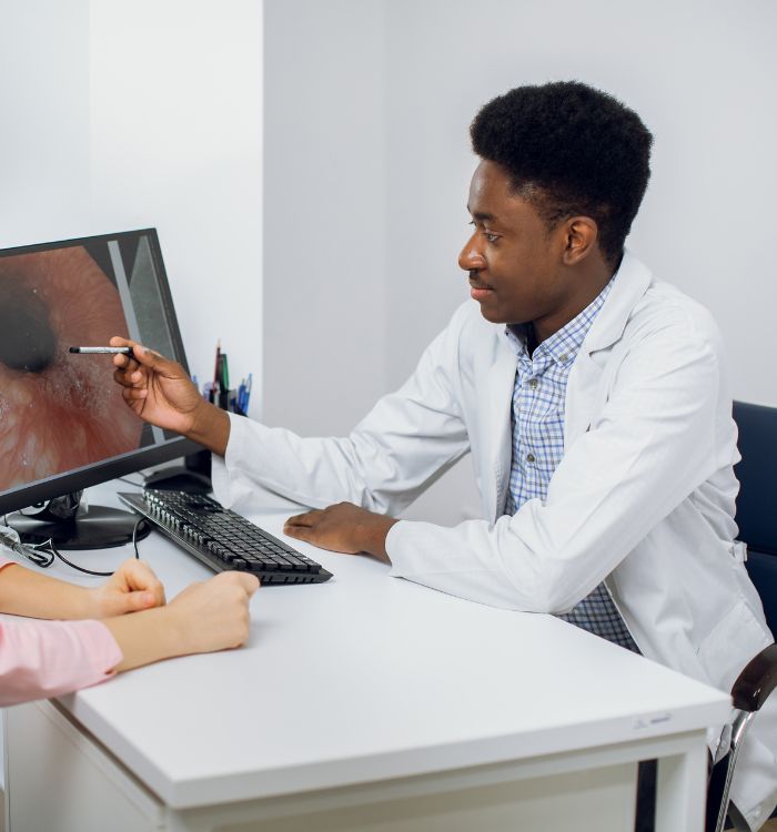 A man and a woman are looking at a computer screen.