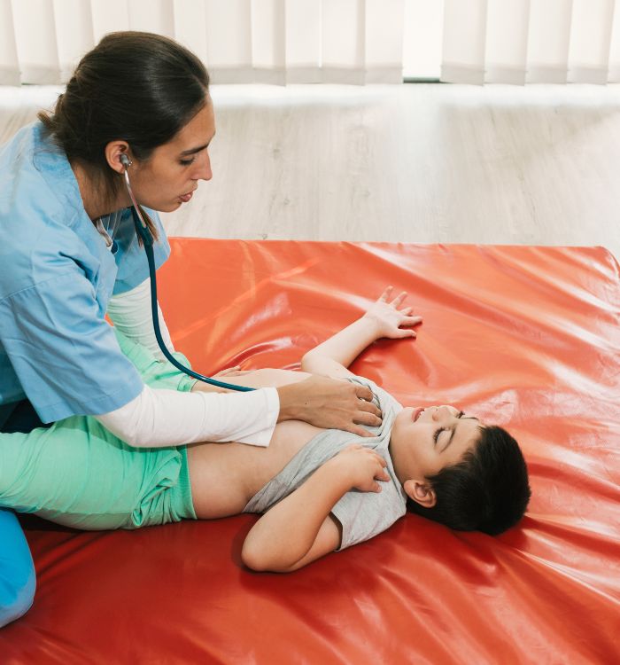 A woman is checking a child's heart rate.
