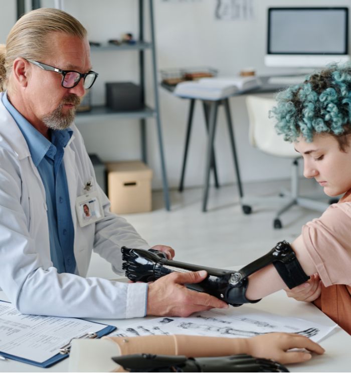A man in a lab coat is examining a woman's arm.