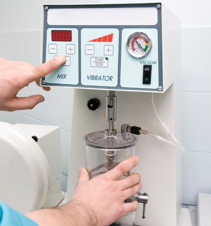 A man is holding a vibrator machine.