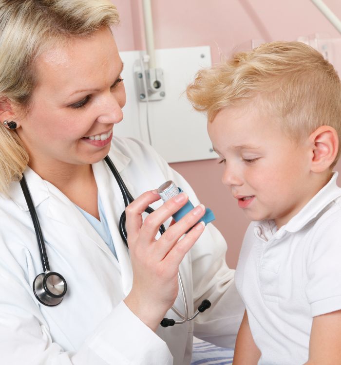 A woman in a white lab coat is showing a young boy a medical device.
