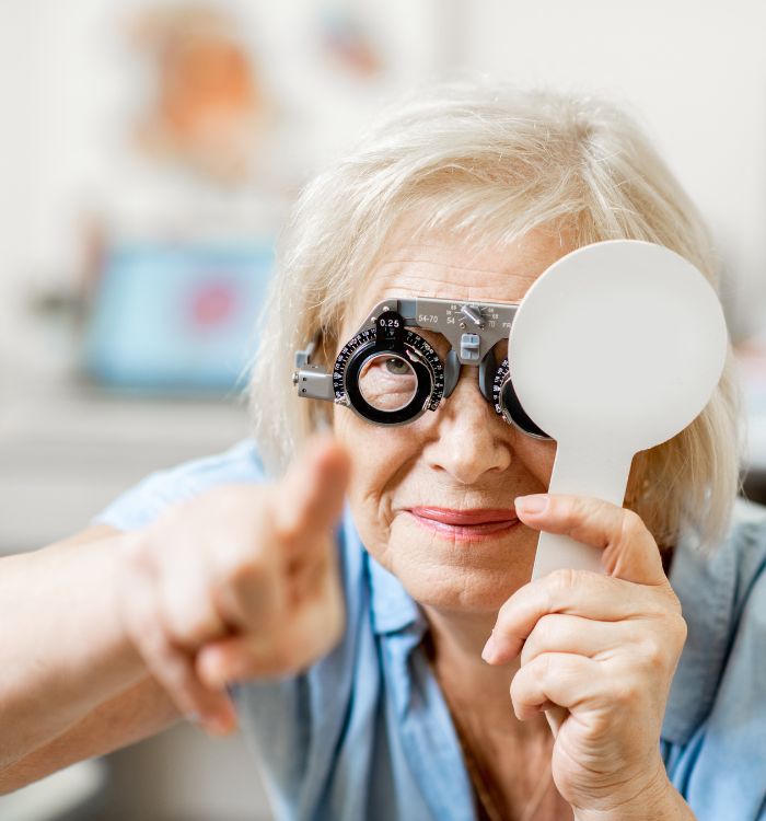 A woman wearing glasses and pointing at something.