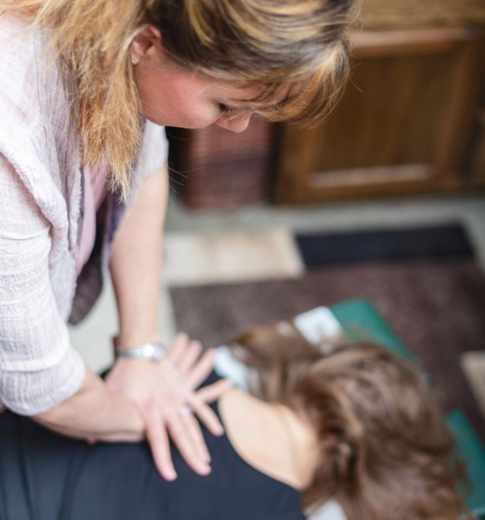 A woman getting a massage from another woman.