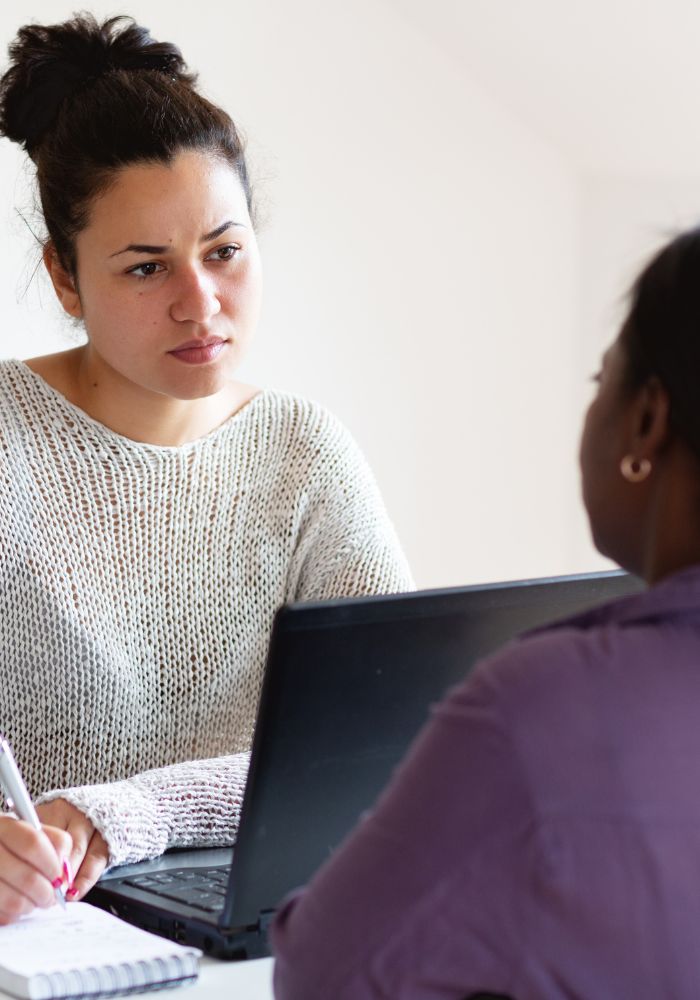 A woman sitting in front of a laptop.