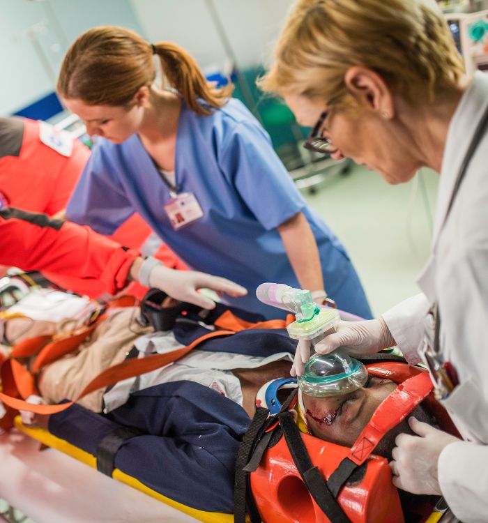 A man is being attended to by a nurse and a doctor.