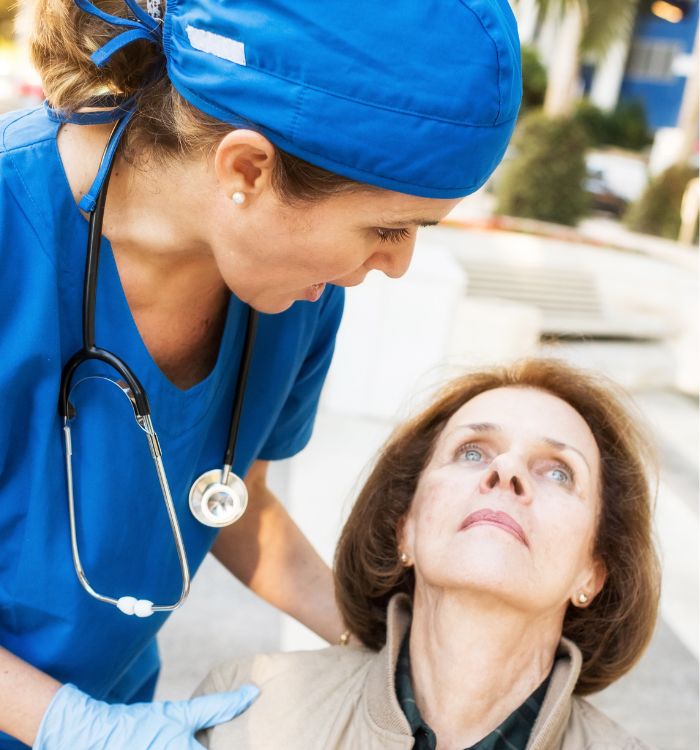 A woman in a blue shirt is helping another woman.