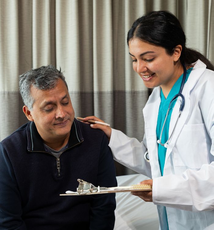 A woman in a white coat holding a tray with a piece of food on it.