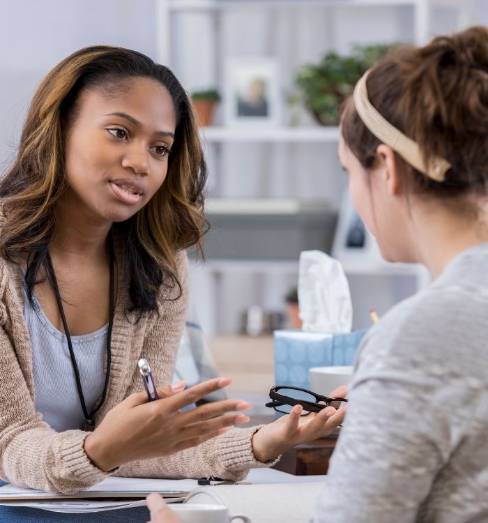 Two women talking in a room.