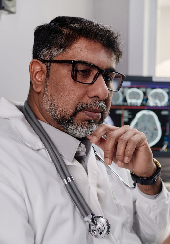 A man wearing glasses and a white lab coat.