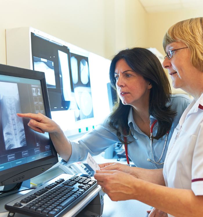 Two women looking at a computer screen.