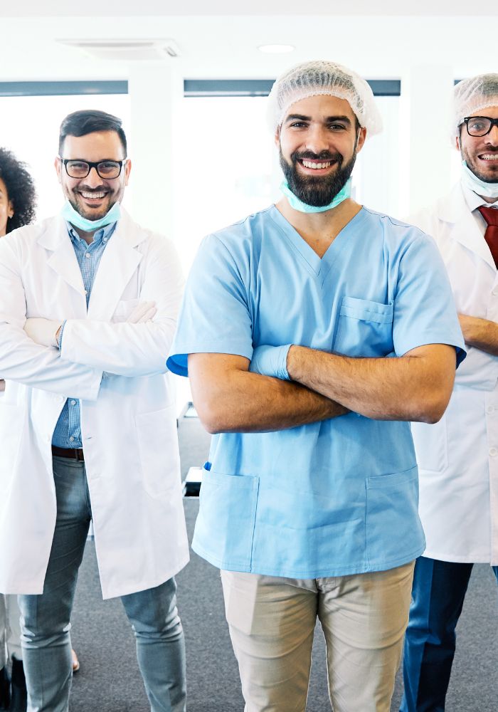 A man wearing a blue shirt and a white hat.