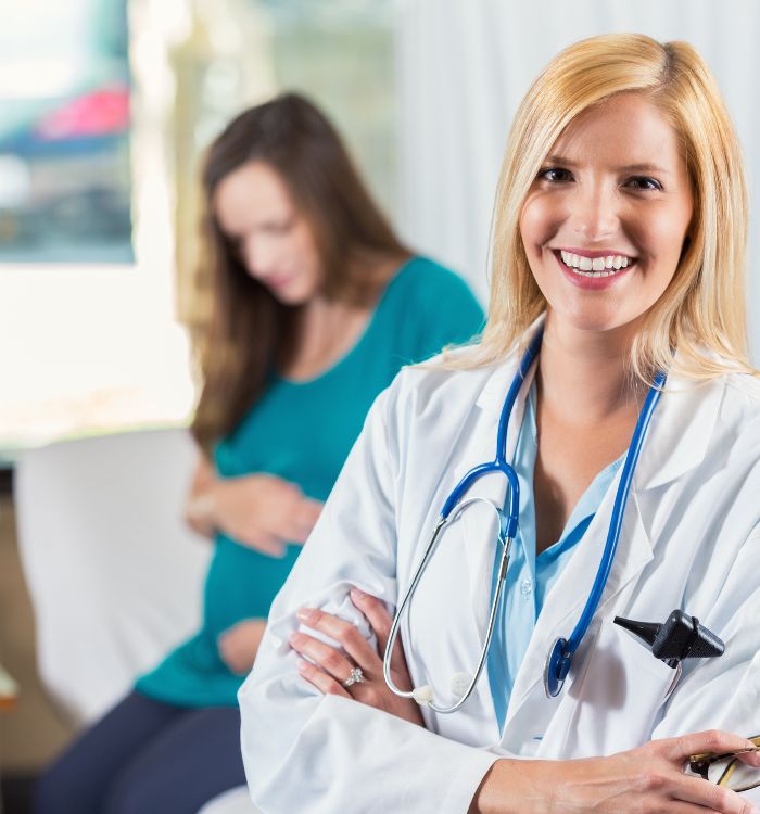 A woman in a white coat with a stethoscope around her neck.